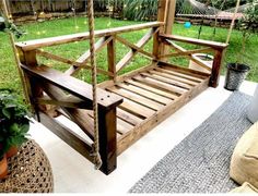 a wooden bed frame sitting on top of a patio