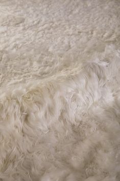 the fur is white and fluffy on the floor