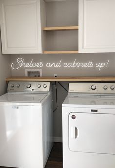 a white washer and dryer sitting next to each other in a laundry room