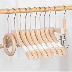 a wooden hanger with six pairs of clothes hanging from it's hooks and clips