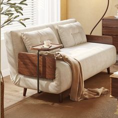 a white couch sitting next to a wooden table