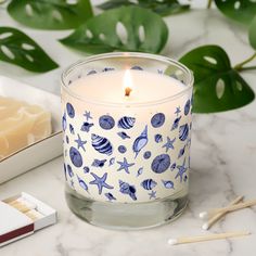 a candle sitting on top of a table next to some matches