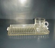 an empty glass and tray sitting on a table