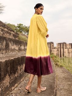 VALUES Handcrafted Organic Fair Minimal Waste CURATOR'S NOTE Make a statement with the Honeycreeper Dress. Crafted from a sumptuous dip-dyed lime yellow mul fabric, the dress features intricate gathers at both the shoulder and back neckline, side buttons to cinch the waist, and flared sleeves for added drama. Fully lined and with two side seam pockets, the Honeycreeper Dress is the perfect blend of sophistication and elegance. THE DESIGNER STORY KHARA KAPAS, meaning 'pure cotton' in Hindi, start Dip Dye Dresses, Crop Top Lehenga, Sequin Saree, Organza Lehenga, Lime Yellow, Ombre Dress, Sustainable Clothing Brands, Wedding Jumpsuit, Yellow Midi Dress