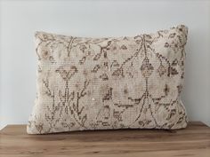 a decorative pillow on a wooden table