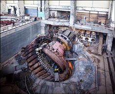 an old building that has been demolished and is being used as a workshop for machinery