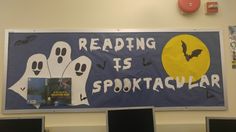 a bulletin board that reads reading is spooktacular with ghost hands and bats