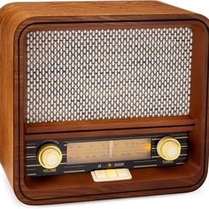 an old fashioned radio with wooden case and metal wire on the front, isolated against a white background