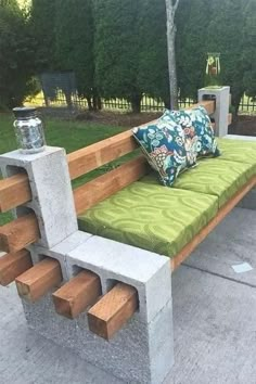 a bench made out of cinder blocks with pillows on it