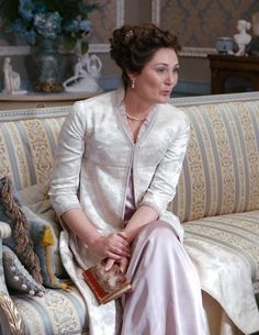 a woman sitting on top of a couch in a living room