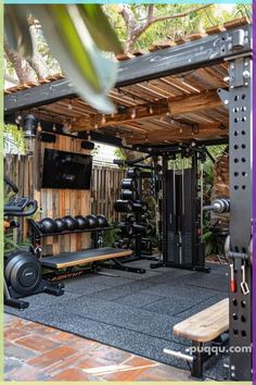 an outdoor gym area with equipment and trees in the background, surrounded by wood planks