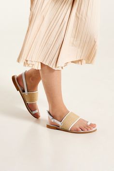 Fashionable and exceptionally comfortable, our Niki flat leather slingback sandals are beautifully handcrafted from premium straw and supple leather in white. These easy-to-wear slingback sandals are designed to be your go-to companion for vacations and summer adventures. Featuring a chic toe loop and a thick instep strap lined and trimmed with soft leather and straw, the Niki women’s sandals exude a timeless charm and effortless sophistication. Slip into luxurious comfort with their leather insole, providing support for all-day wear. The lightweight EVA outsole ensures maximum comfort making these flat strappy sandals ideal for exploring new destinations. Their modern silhouette pair perfectly with jeans and dresses. Flat Strappy Sandals, Toe Loop Sandals, Sandals Strappy, Slingback Flats, Slingback Sandals