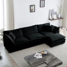 a black couch sitting on top of a white rug