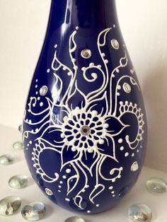 a blue vase with white designs on it