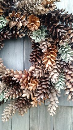 a wreath made out of pine cones and leaves