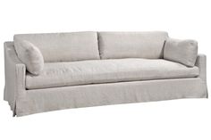 a white couch with two pillows on it