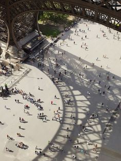 an aerial view of people walking around in front of the eiffel tower