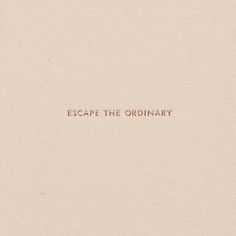 the words escape the ordinary written in red ink on a white paper with a brown border