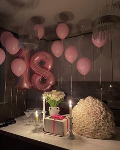 a table with balloons and candles on it