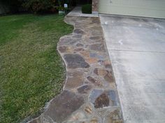 a stone walkway in front of a house