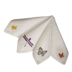 three white kitchen towels with embroidered butterflies on them