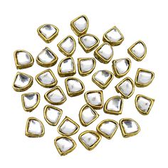 gold plated metal triangle shaped beads with white and black dots on the top, set in