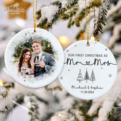 two personalized christmas ornaments hanging from a tree