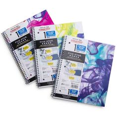 three spiral notebooks with different designs on them