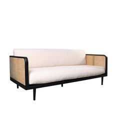 a white couch sitting on top of a wooden frame