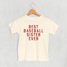 a white t - shirt with the words best baseball sister ever printed in red on it