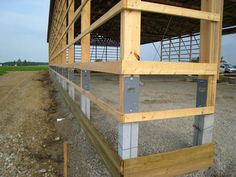 a wooden structure sitting on top of a dirt field