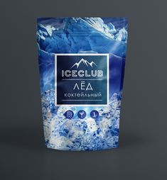 a bag of ice club tea with mountains in the background on a dark grey surface