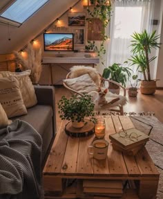 a living room filled with furniture and a flat screen tv on top of a wooden table