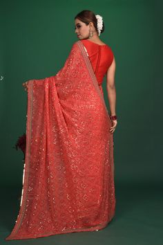 Be a vision of elegance at parties in this exquisite red bandhej and sequin georgette saree. It comes with a matching blouse piece. Shop designer sarees online in USA from Pure Elegance. DISCLAIMER:- The shown stitched blouse on the model is for display purpose only. The saree comes with a matching blouse piece and finished with fall and piko.