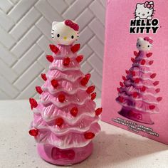 a hello kitty christmas tree in front of a pink box