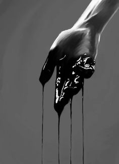 a black and white photo of a dripping hand