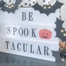 a lighted sign that says be spook, tacular and bats on it