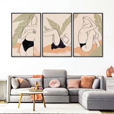 a living room with two paintings on the wall