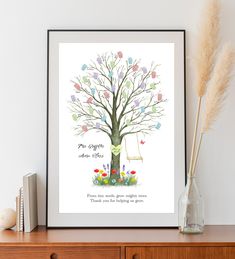 a tree with leaves and flowers in front of a white wall next to a book shelf