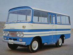 an old blue and white bus parked in a parking lot