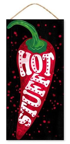 a red hot chili sign hanging on a rope with the word hot sauce painted on it