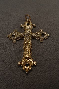 I am offering this fabulous vintage yellow gold tone pendant. This piece is truly gorgeous, and it has the following features:  * beautiful vintage pendant * yellow gold tone * cross * floral design * religious design * 2.5 inches in length This is a fantastic and classic piece. There is tons of sparkle and shine with this piece. It will beautifully complement your upcoming fashion season. Buyer pays all shipping and handling. Cross Jewelry Gold, Spicy Chips, Cross Jewelry Necklace, Gold Cross Necklace, Gold Cross Pendant, Funky Jewelry, Jewelry Lookbook, Vintage Pendant, Cross Design