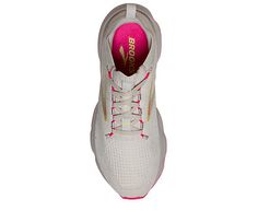 a woman's white tennis shoe with pink laces on the bottom and side