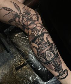 a person with a clock and roses tattoo on their arm