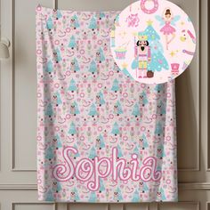 a pink and blue personalized towel hanging from a hook on a door with the name sophia printed on it