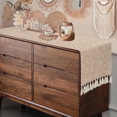 a dresser with some decorations on top of it