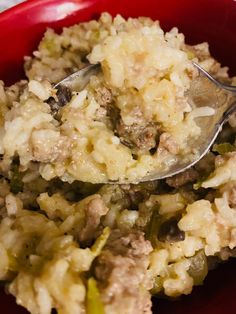 a red bowl filled with food and a spoon