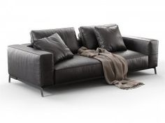 a black leather couch with two pillows on the armrests and a blanket draped over it