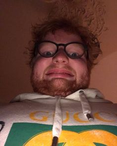 a man with glasses and a beard wearing a sweatshirt