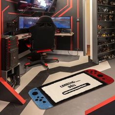 a gaming room with a rug that has a video game controller on it, and a computer desk in the background